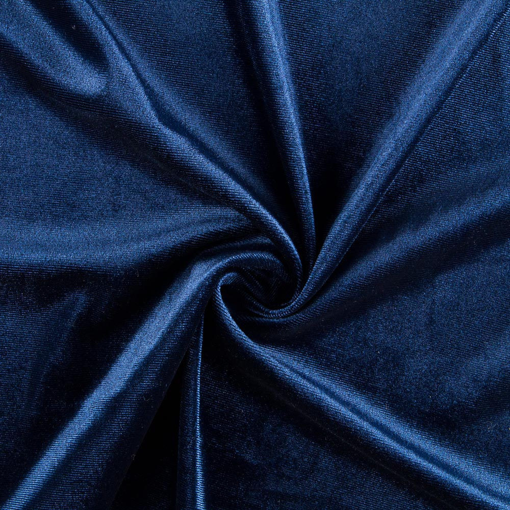 Close-up of rich blue velvet arranged in folds, revealing the depth of its color and the way light moves across its surface.